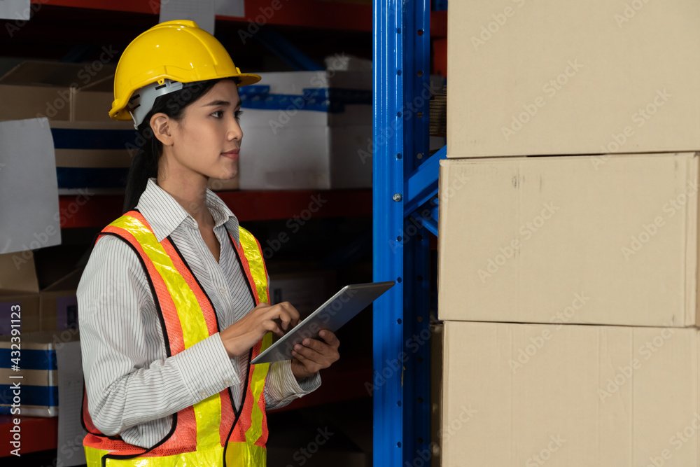 Female warehouse worker working at the storehouse . Logistics , supply chain and warehouse business 