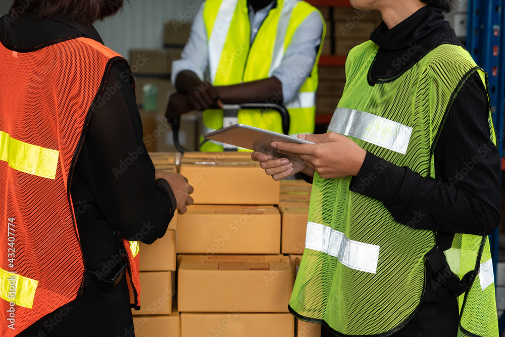 Warehouse worker working together in the storehouse . Logistics , supply chain and warehouse busines