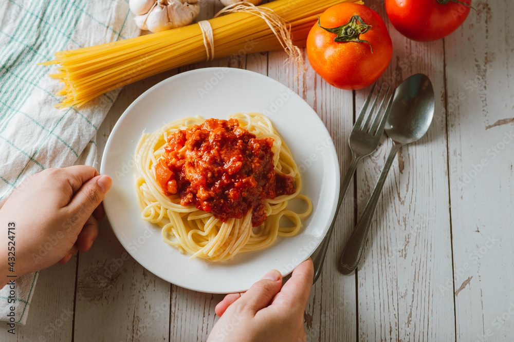 Delicious homemade Spaghetti pasta with tomato sauce and minced meat served on a white plate with in