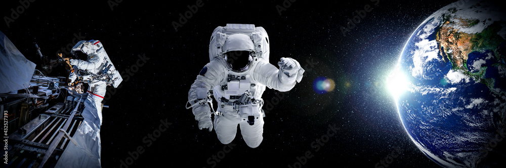 Astronaut spaceman do spacewalk while working for space station in outer space . Astronaut wear full