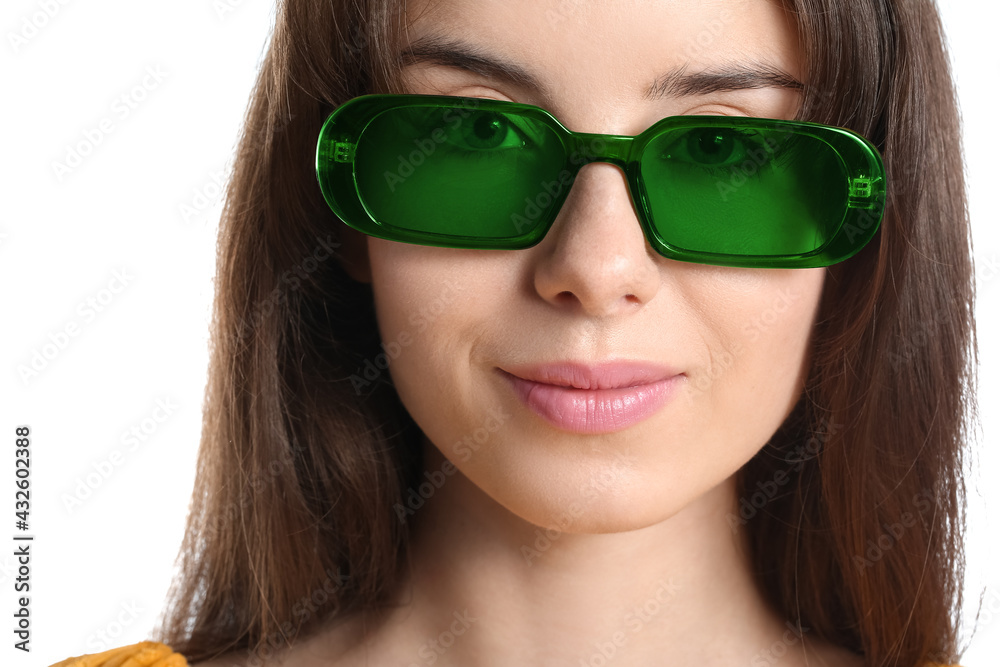 Beautiful young woman with stylish sunglasses on white background