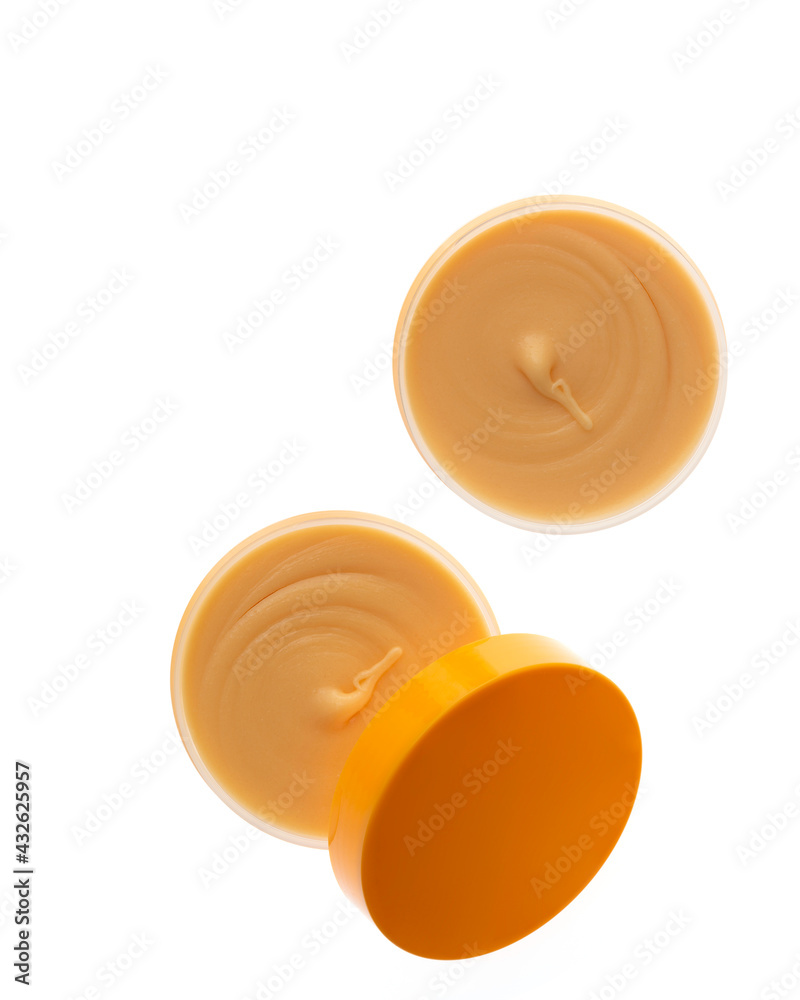 Cosmetic cream with honey ingredient in container isolated on white