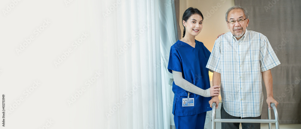 Portrait of Asian old man standing with female nurse in nursing home.