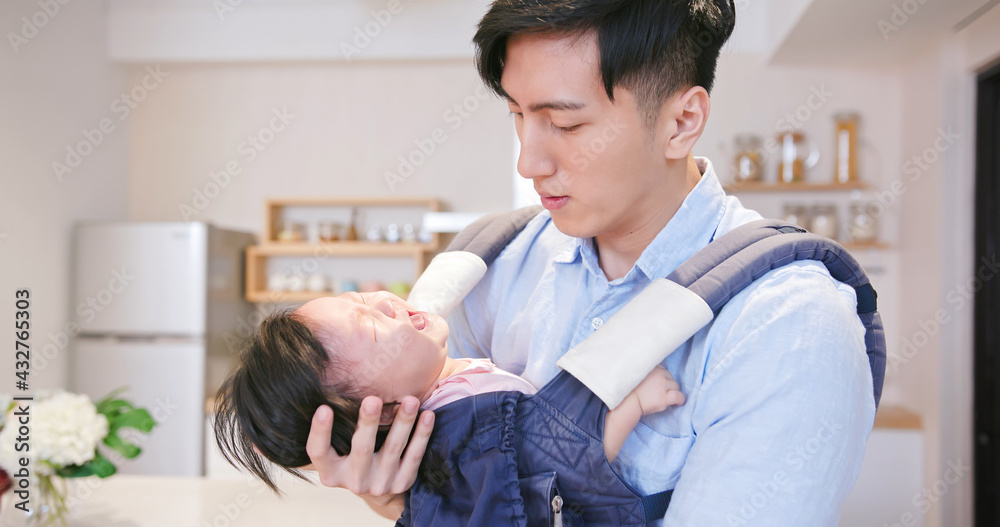 father holding crying baby daughter