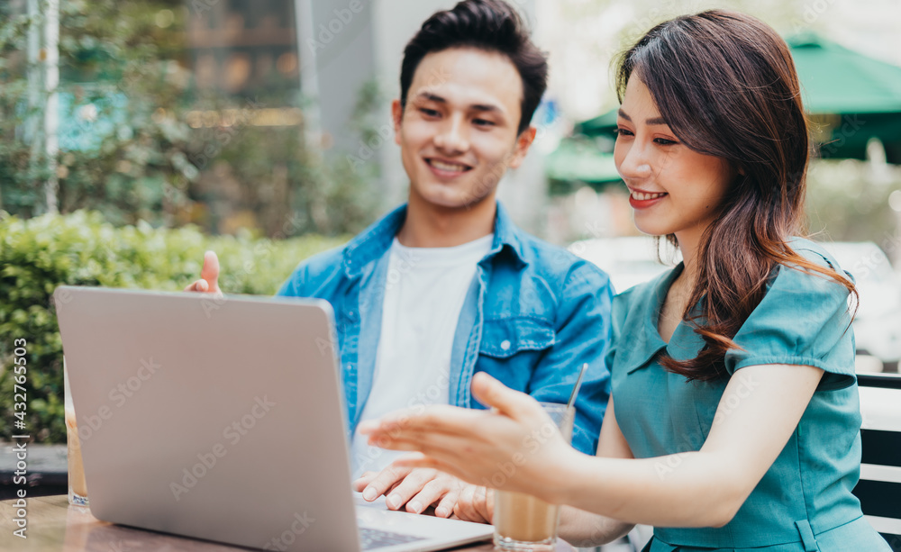 Young Asian people working together at coffee shop