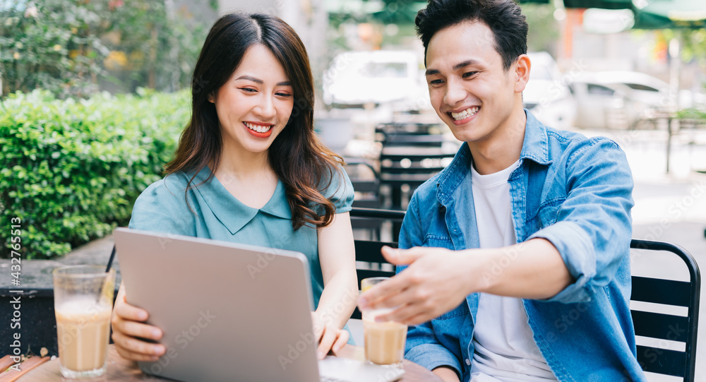 Young Asian people working together at coffee shop