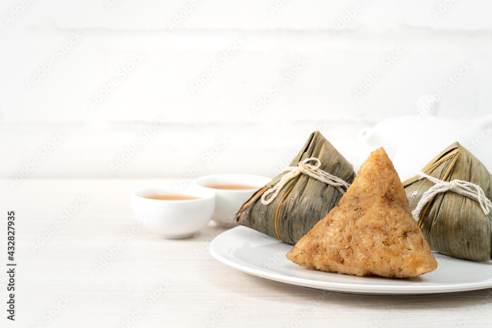 Zongzi. Rice dumpling for Dragon Boat Festival on bright wooden table background.