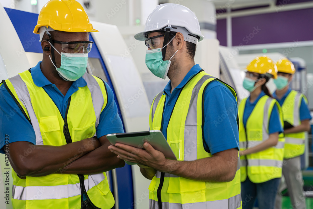 Factory workers meeting before work And put on a mask