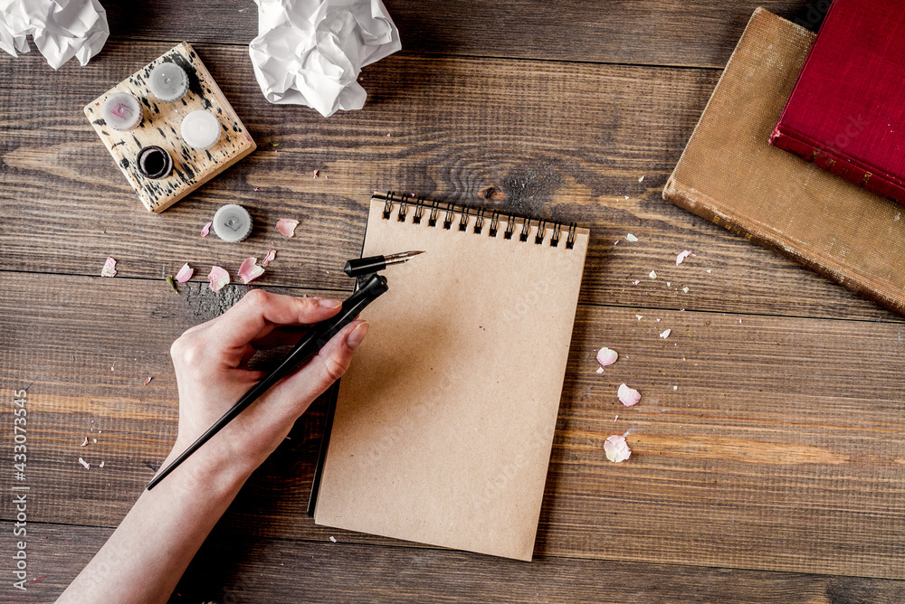 Writer workplace with tools on wooden background top view