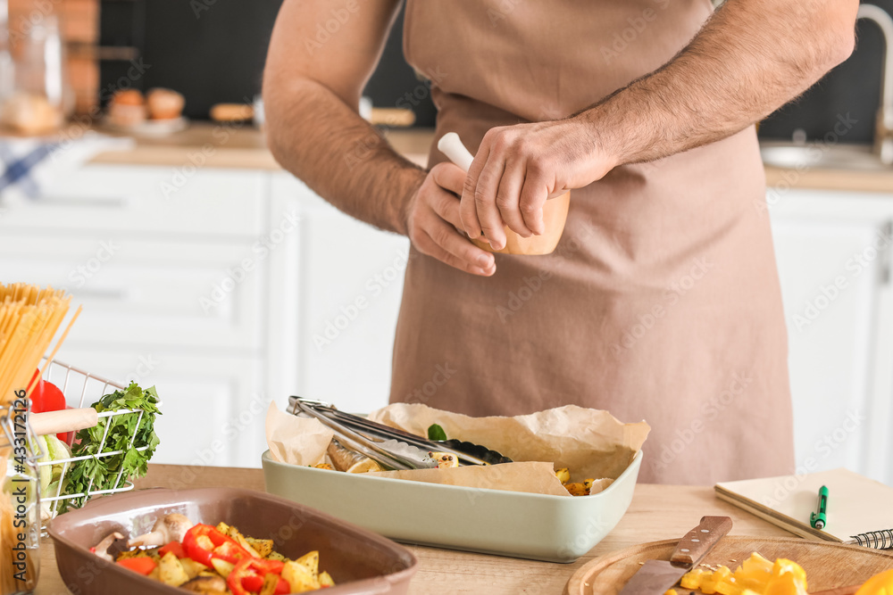 Young man cooking in kitchen