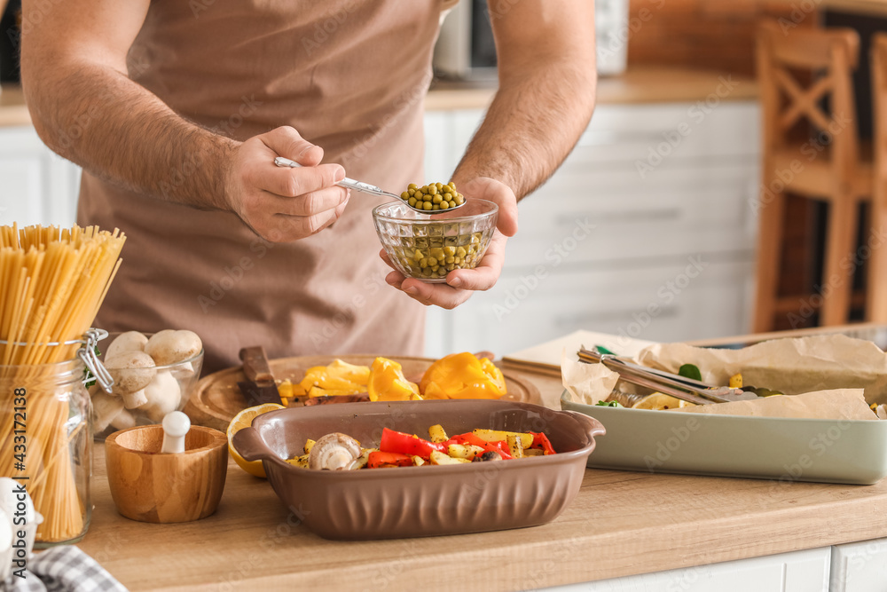 Young man cooking in kitchen