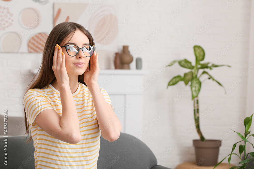 Young woman wearing eyeglasses at home