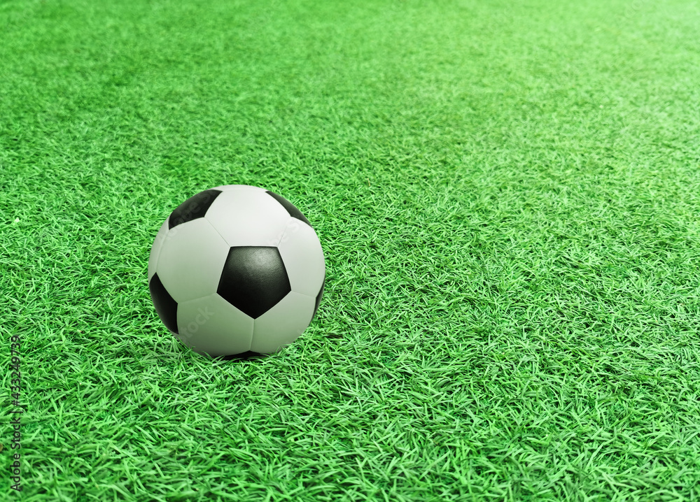 Soccer ball on green field