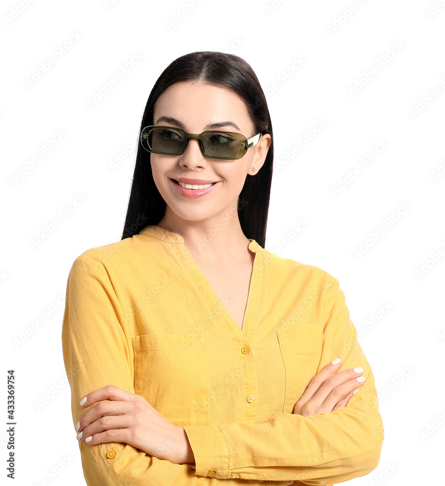 Beautiful young woman wearing stylish sunglasses on white background