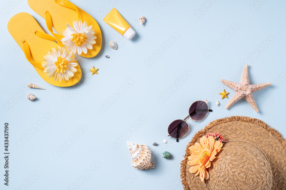 Summer beach background design concept with shells, hat, slipper on yellow background.