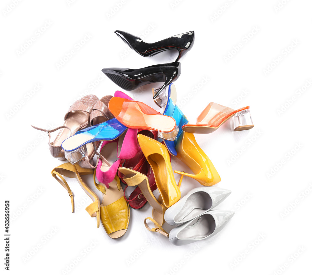 Heap of different shoes on white background