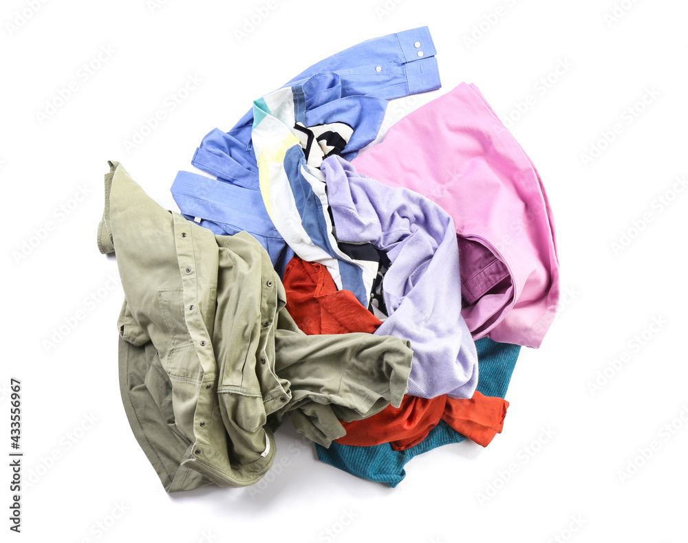 Heap of different clothes on white background