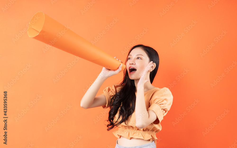 Asian woman using a paper speaker, Concept announces