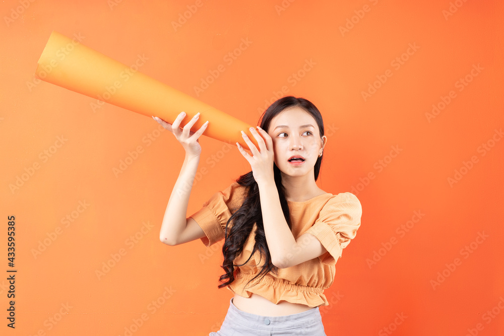 Asian woman using a paper speaker, Concept announces