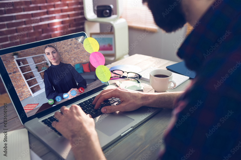 Caucasian businessman sitting at desk using laptop having video call with female colleague