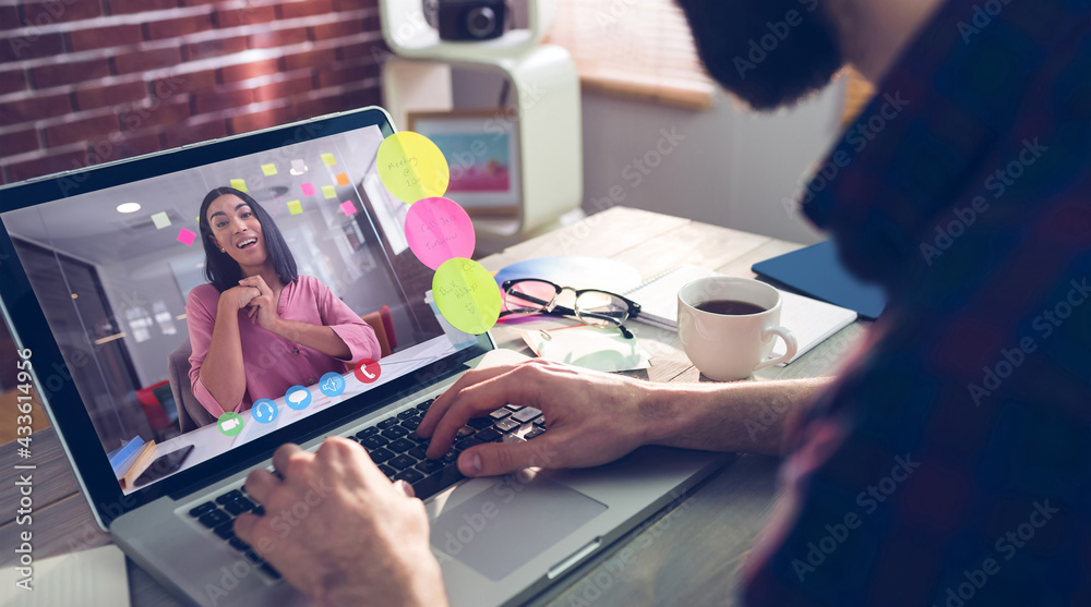 Caucasian businessman sitting at desk using laptop having video call with female colleague