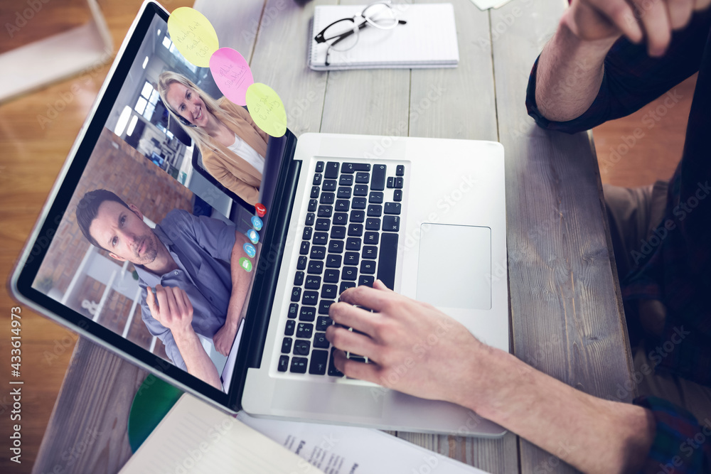 Caucasian businessman sitting at desk using laptop having video call with male and female colleagues