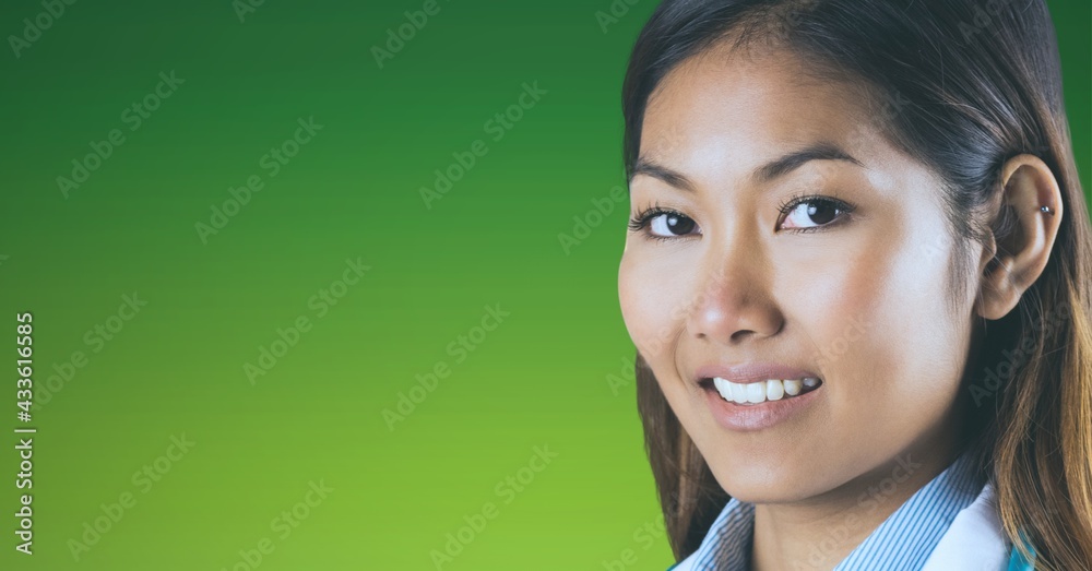 Portrait of asian female doctor smiling against green and yellow gradient background