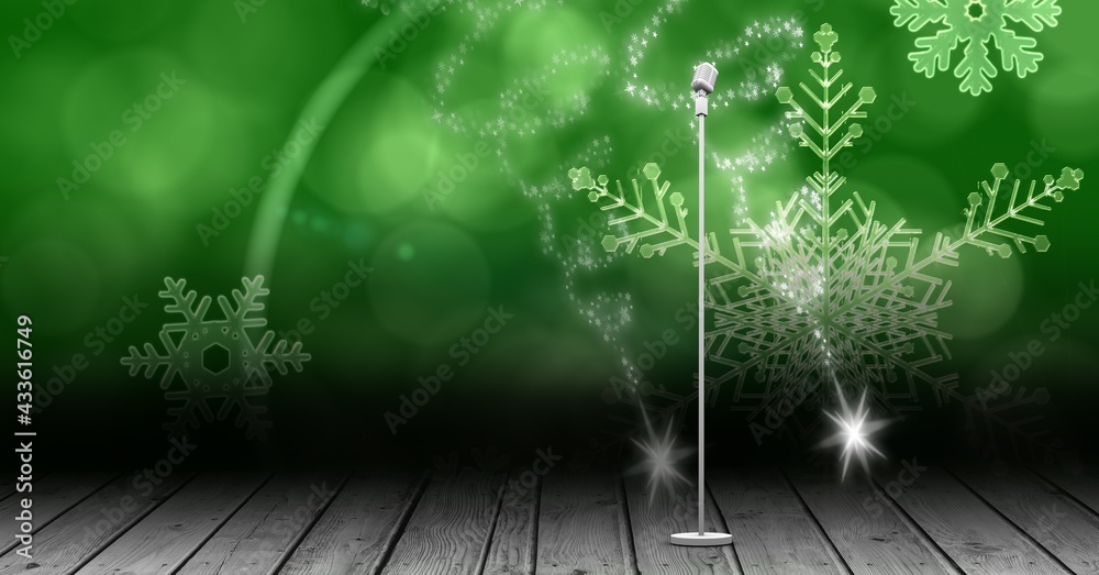 Vintage microphone on a stand over green snowflakes background, performance and holiday concepts