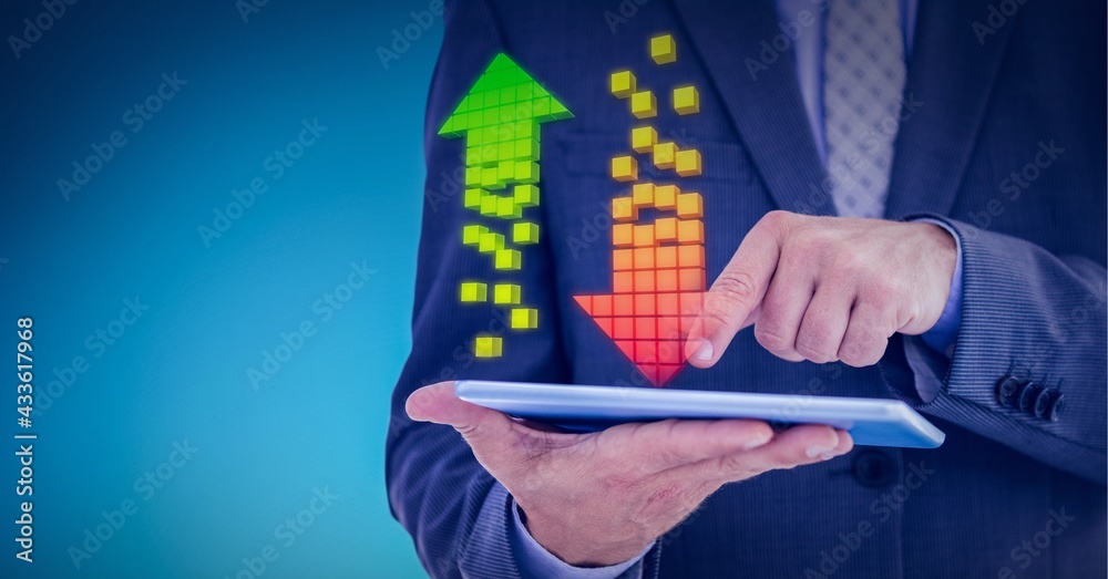 Multiple arrows over mid section of businessman holding digital tablet against blue background