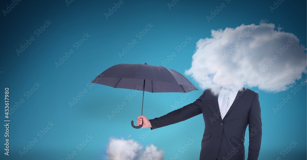 Cloud covering face of businessman holding an umbrella against blue background