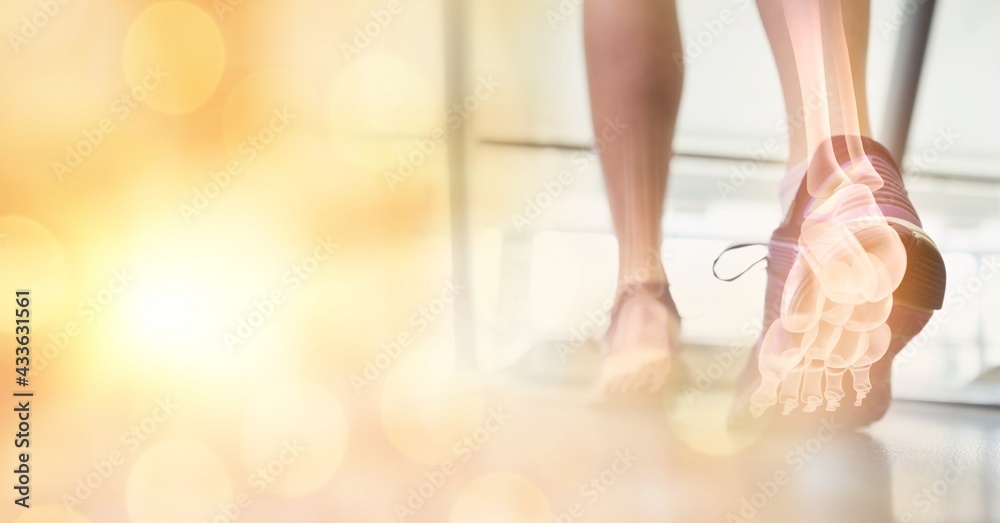 Composition of spots of light over woman running on treadmill with foot bones showing