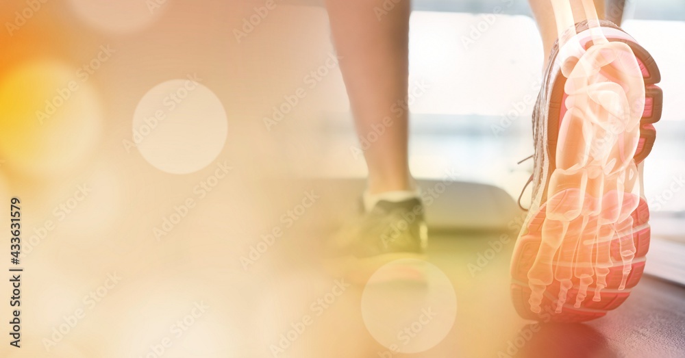 Composition of spots of light over woman running on treadmill with foot bones showing