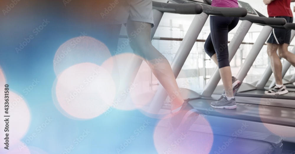 Composition of man running on treadmill with red spot on ankle showing injury with spots of light