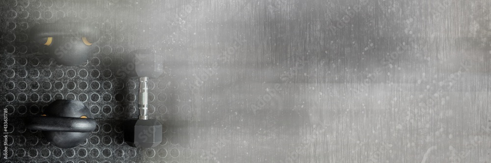 Composition of kettlebells on gym floor with blurred grey light