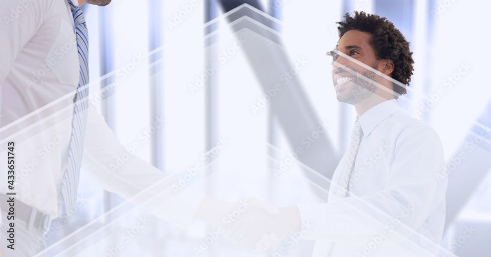 Composition of businessmen shaking hands over white arrows and modern office