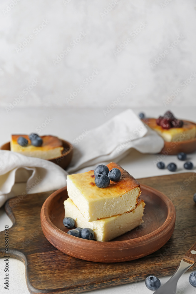 Plate with pieces of cottage cheese casserole on table