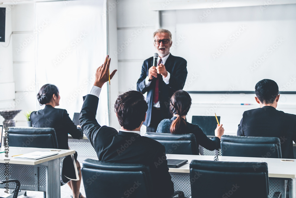 Senior leader speaker speaks to public people audience in training workshop or conference. Mature le