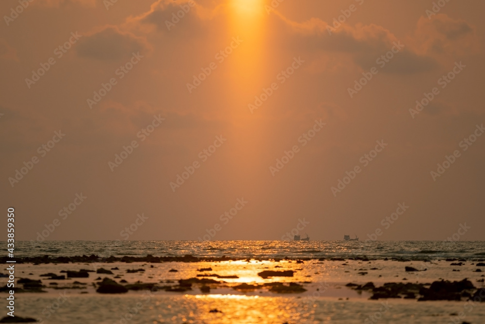 Amazing light of Sunset or sunrise over sea landscape nature with rocks in the foreground