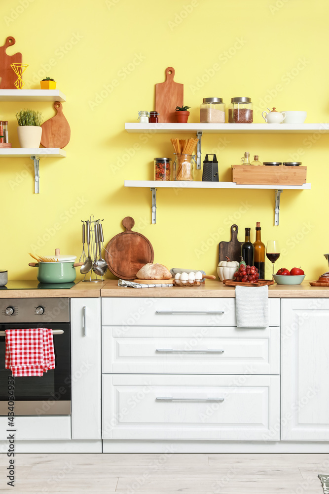 Cooking utensils and products on table in interior of modern kitchen