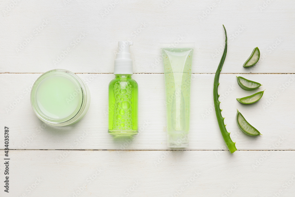 Cosmetic products with aloe on light wooden background