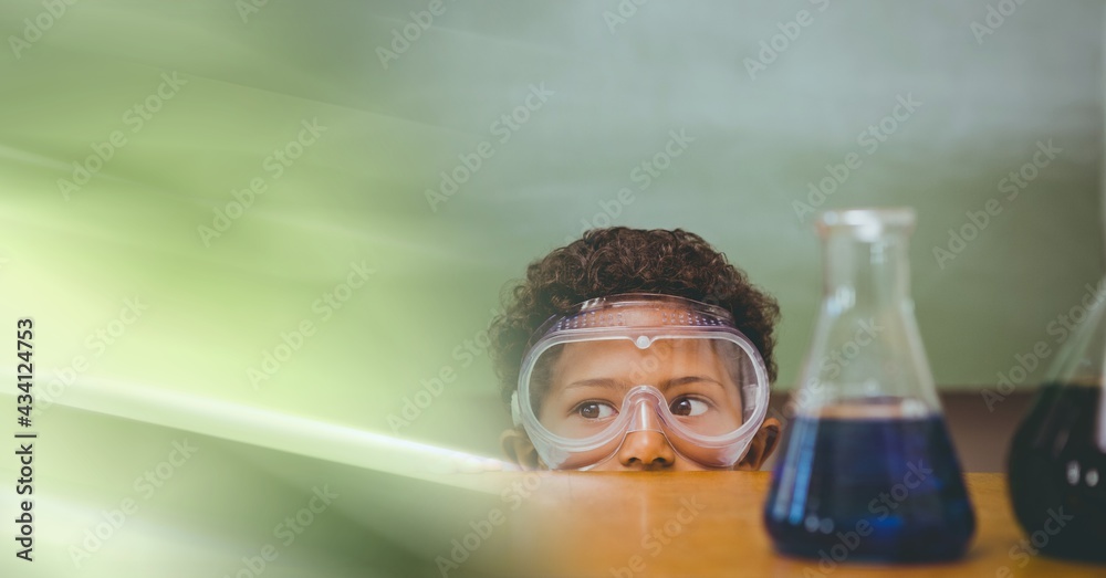 Composition of african american boy in lab with flasks, wearing goggles with motion blur