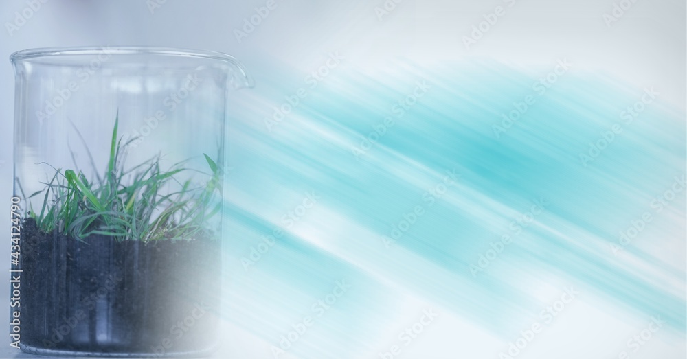 Composition of beaker with plant lying in lab with motion blur