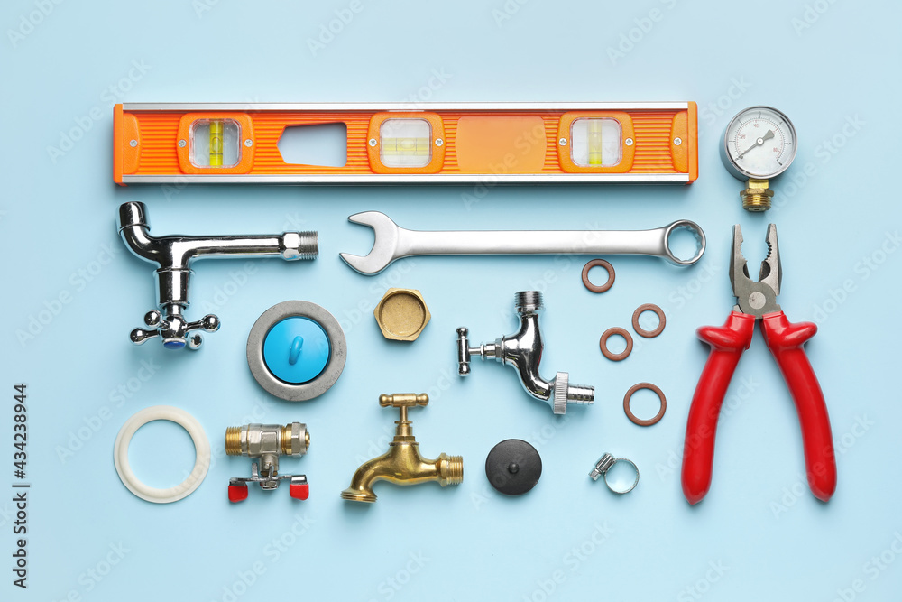 Set of plumbers items on color background