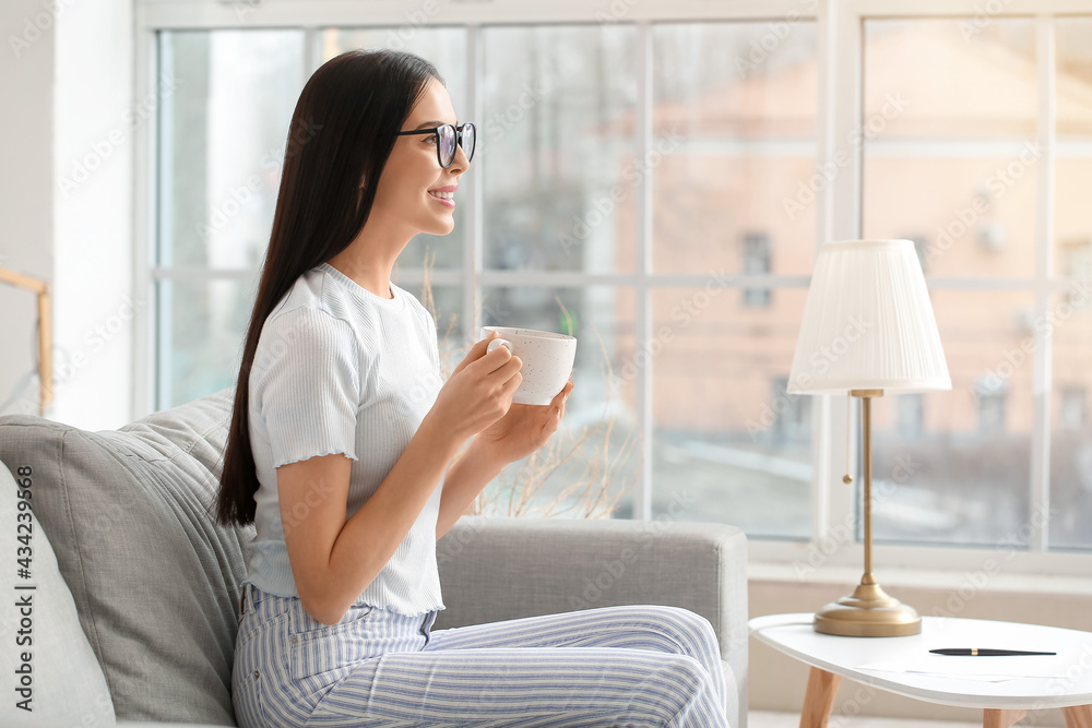 Young woman drinking coffee at home