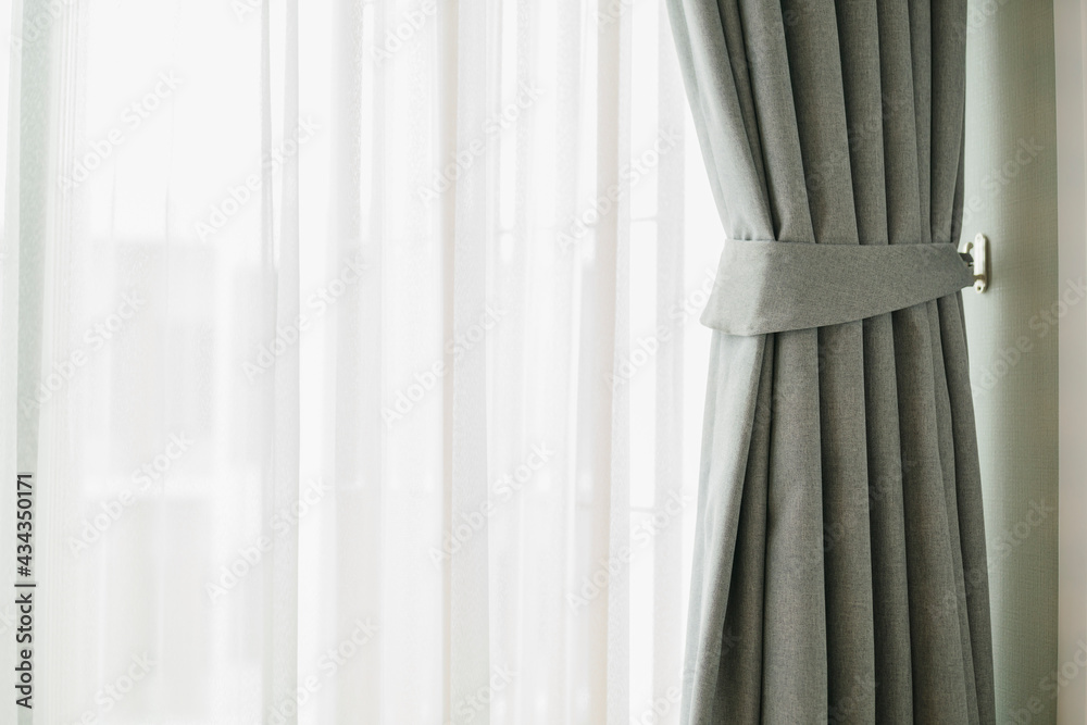 Glass window with white translucent curtain.Close up sheer curtain with beautiful sunlight in the mo