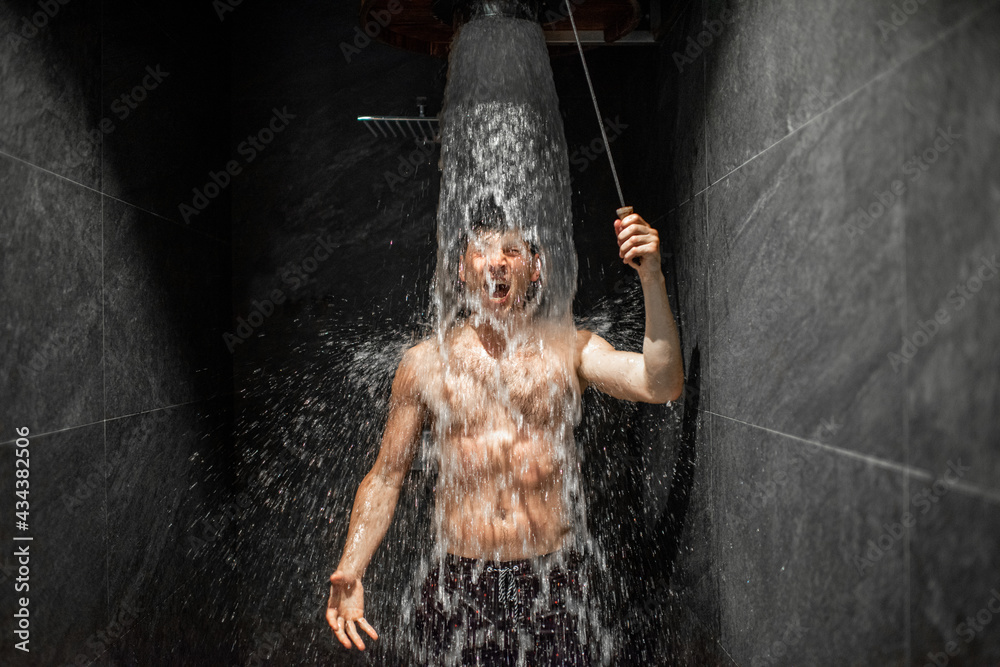 Man hardening with bucket of ice cold water after hot sauna, healthy lifestyle and cold training con