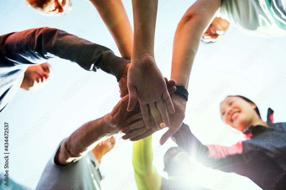 Team members' hands all in the center