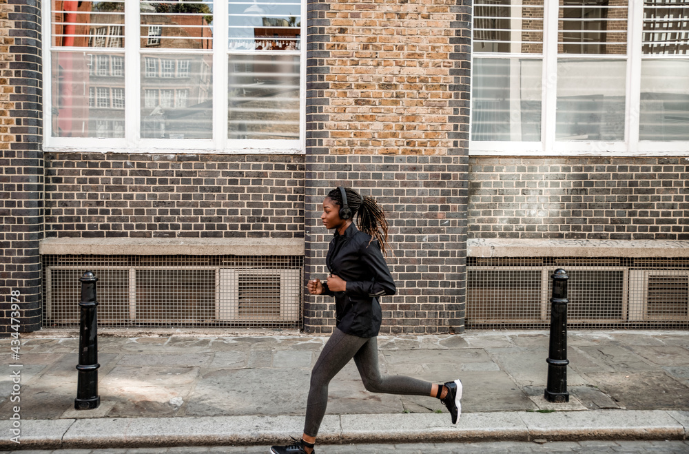 Woman jogging through the city