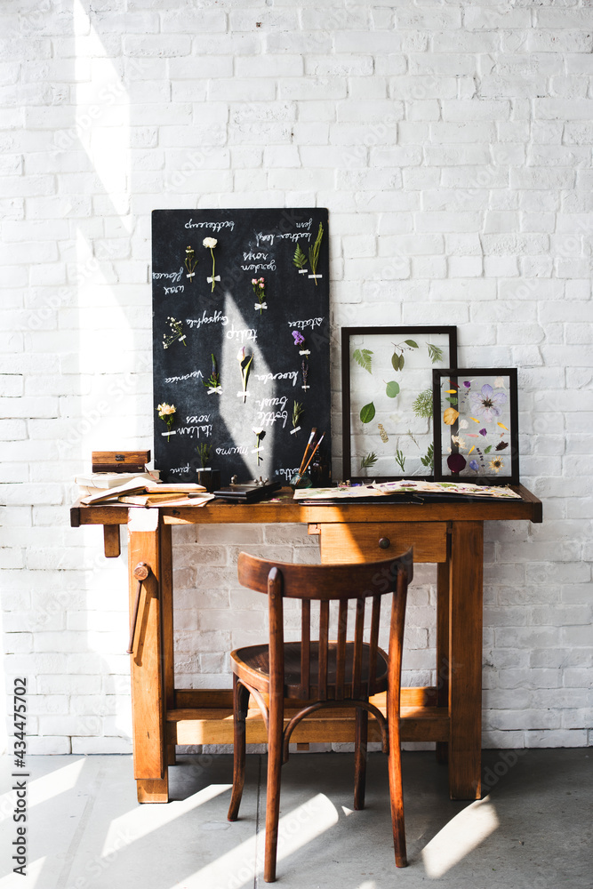 Workspace of Florist with Dry Flowers Name List on Black Board