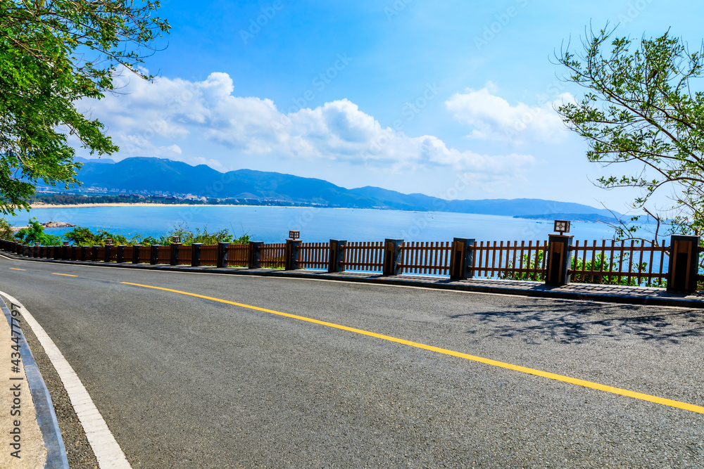 Mountain highway with blue sky and sea landscape.